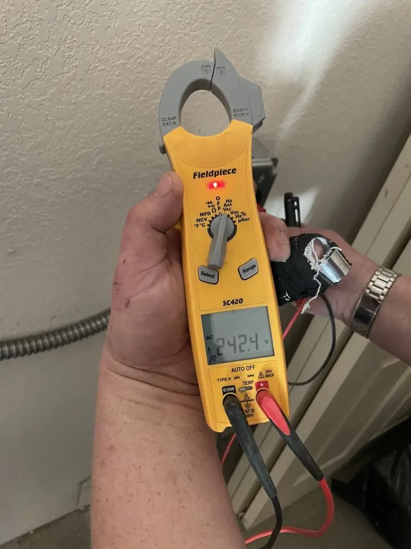 Voltage testing with clamp meter during Outlet Installation in Irvine